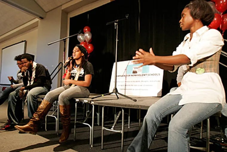Shania Morris (middle) of the Philadelphia Student Union performs at the Youth Power Summit at Community College of Philadelphia. Clapping at right is Juele Stokes. (David Swanson / Staff Photographer)