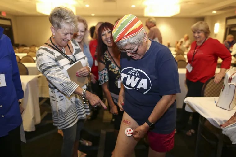 Silver Wings International member Pauline Fazio shows off the TWA tattoo on her thigh during their yearly convention Saturday.