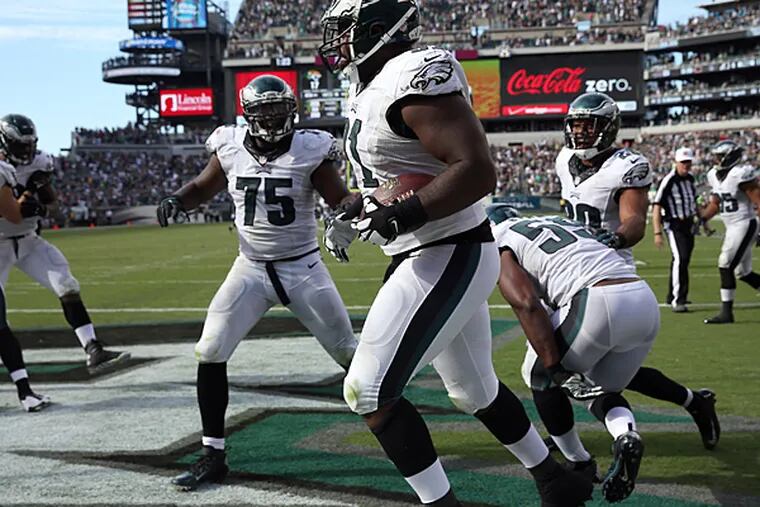 The Eagles defense celebrates after Fletcher Cox scored a touchdown after a fumble recovery against the Jaguars. (David Maialetti/Staff Photographer)