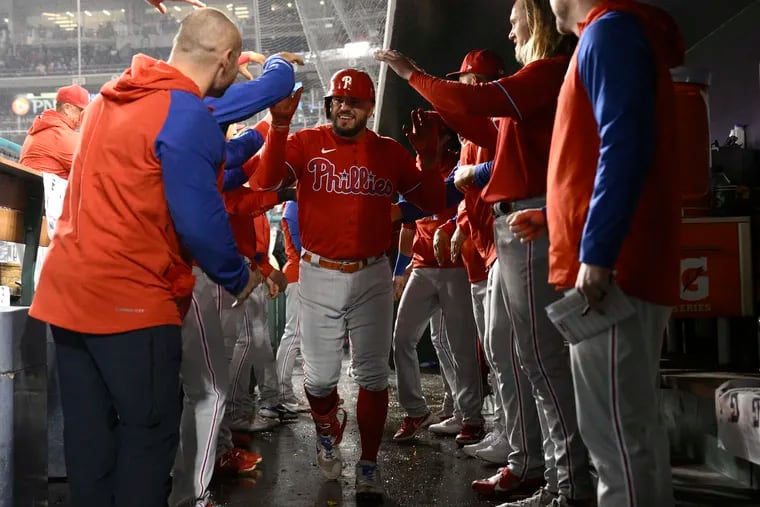 Philadelphia Phillies' Kyle Schwarber, center, is congratulated for his home run during the fourth inning of the second baseball game of the team's doubleheader against the Washington Nationals on Saturday in Washington.