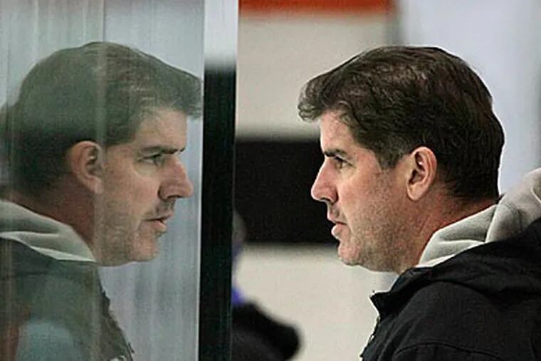 Peter Laviolette has become an assistant for his 14-year-old son's hockey team. (Elizabeth Robertson/Staff Photographer)