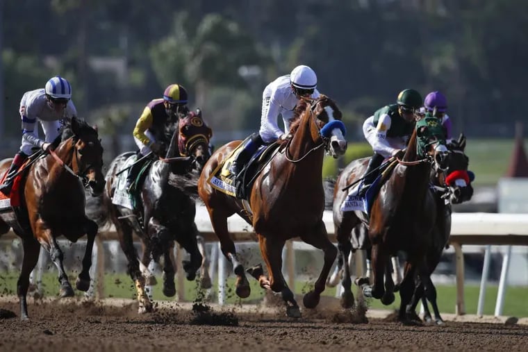 Justify (center), with jockey Mike Smith aboard, won the Santa Anita Derby by three lengths.