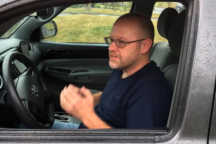 Shawn Gill at the wheel of his 2014 Toyota Tacoma that he drove for Lyft and Uber until his license was suspended as a result of identity theft.