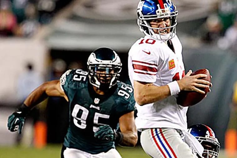 Eagles linebacker Mychal Kendricks tracks down Giants quarterback Eli Manning in the pocket. (Ron Cortes/Staff Photographer)