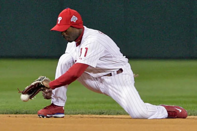 Jimmy Rollins may have bobbled this groundball during the World Series, but at least his ears were warm. The same flap-eared cap Rollins wore will go on sale to the public next weekend. (Jerry Lodriguss / Staff Photographer)