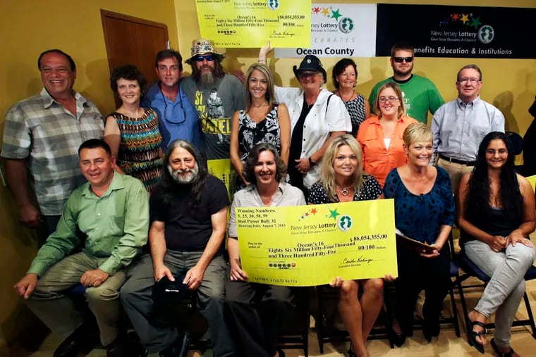 The 16 jackpot winners were all smiles as they appeared at the Ocean County Public Library.