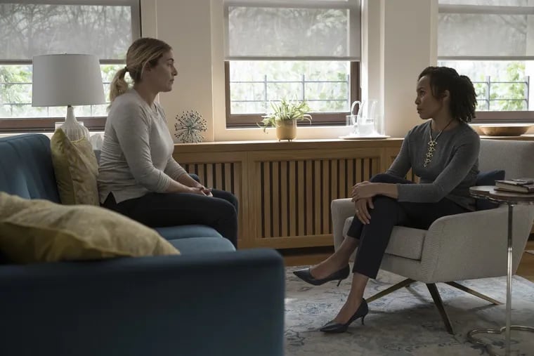 Kate Winslet (left) as Mare Sheehan and Eisa Davis as Mare's therapist, Gayle Graham, in a scene from "Mare of Easttown." A Philadelphia area therapist, Ariel Stern, was a consultant on the show.