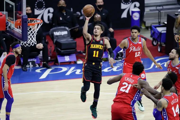 Atlanta Hawks guard Trae Young shoots the basketball past the Sixers defense in Game 1 of the NBA Eastern Conference playoff semifinals on Sunday.