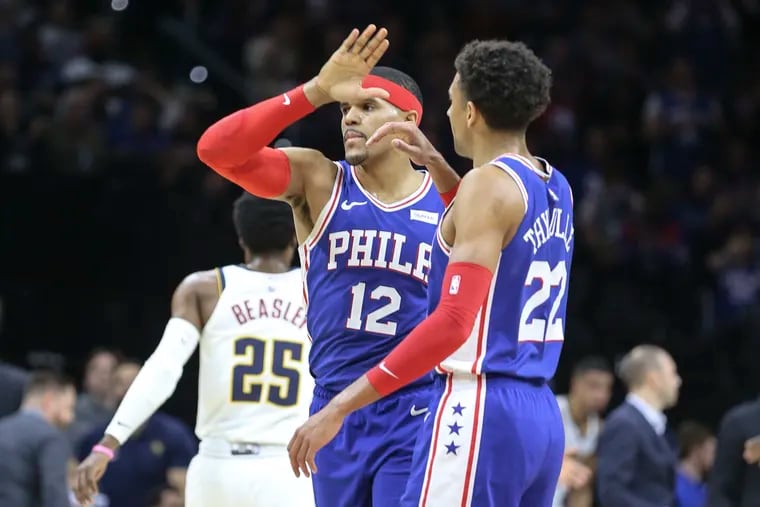 The Sixers' Tobias Harris (12) celebrates with teammate Matisse Thybulle in front of the Nuggets' Malik Beasley during the second quarter.