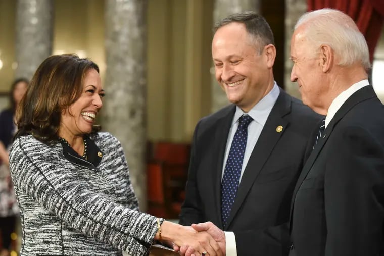 FILE - In this Jan. 3, 2017, file photo, then-Vice President Joe Biden, right, shakes hands with Sen. Kamala Harris, D-Calif., as her husband Douglas Emhoff, watches during a a mock swearing in ceremony in the Old Senate Chamber on Capitol Hill in Washington. Most of the two dozen White House hopefuls have pre-existing friendships from their time on Capitol Hill or other Democratic circles. But few are as complex _ and potentially awkward _ as the tie between Harris and Biden.