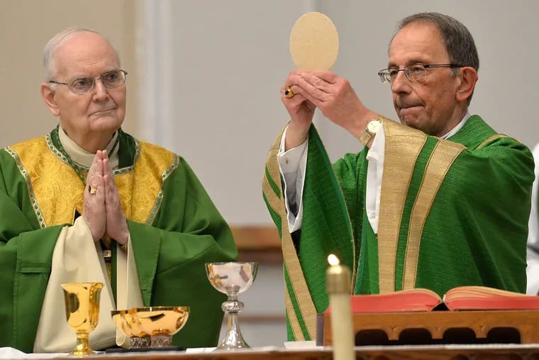 Erie Catholic Bishop Emeritus Donald Trautman, left, and Erie Catholic Bishop Lawrence T. Persico celebrate Communion during Mass at St. Peter Cathedral in Erie this February. As part of the two-year investigation into clergy sex abuse, Persico spoke directly to the grand jury.