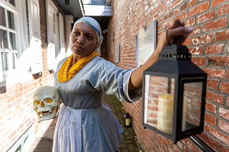 Courtney Mitchell, 36, plays a Cake Baker at the Betsy Ross House. Here she poses as part of the site's Spooky Twilight Tours.