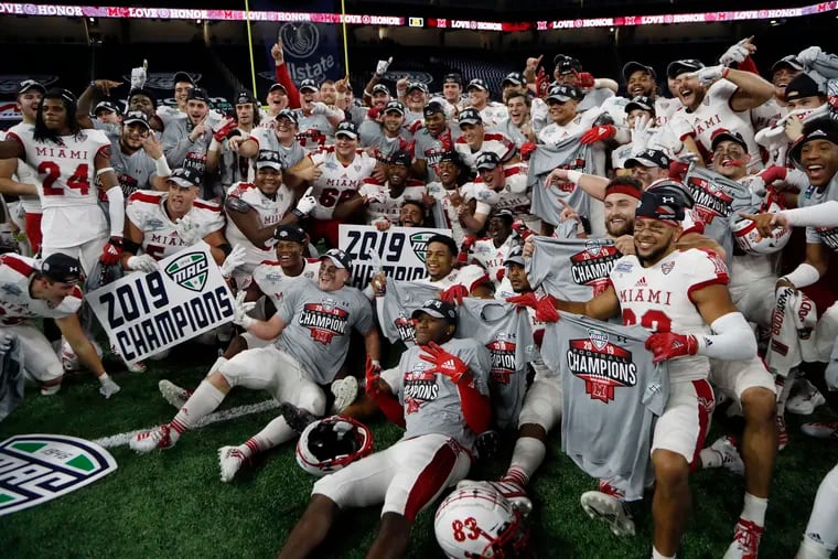 In this Dec. 7, 2019, file photo, members of the Miami of Ohio team pose on the field after the Mid-American Conference championship NCAA college football game against Central Michigan, in Detroit. The Mid-American Conference on Saturday became the first league competing at college football’s highest level to cancel its fall season because of COVID-19 concerns. A person with knowledge of the decision told The Associated Press the university president’s voted to not play in the fall and consider a spring season. The person spoke to AP on condition of anonymity because an official announcement was still being prepared.