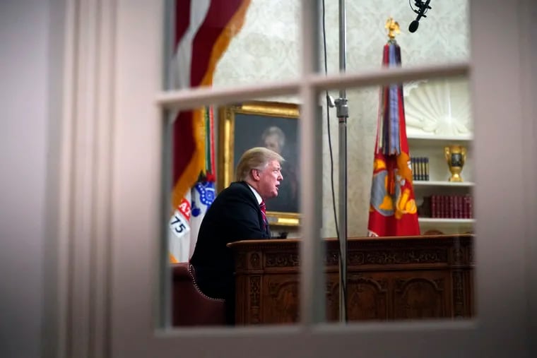 Seen from a window outside the Oval Office, President Donald Trump gives a prime-time address about border security Tuesday, Jan. 8, 2018, at the White House.