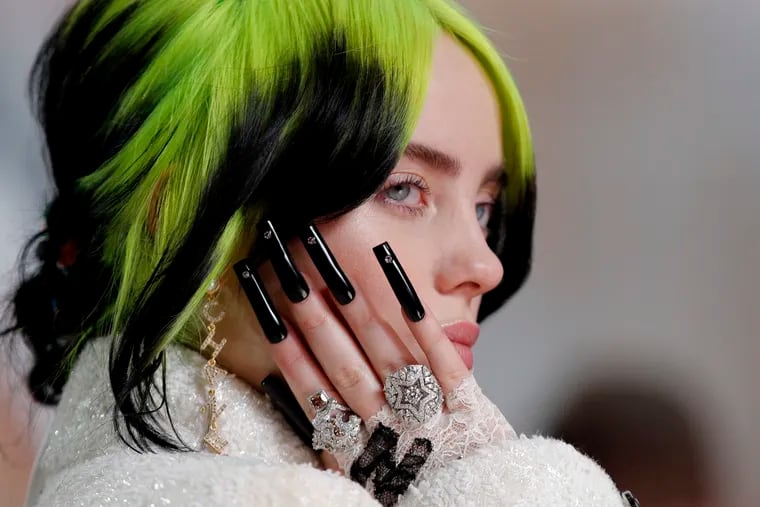 Billie Eilish arrives at the Oscars at the Dolby Theatre in Los Angeles on Feb. 9.  At the U.K. music industry’s Brit Awards on Feb. 18, 2020 in London Eilish, 18, gave her first public performance of her James Bond theme song “No Time to Die.”