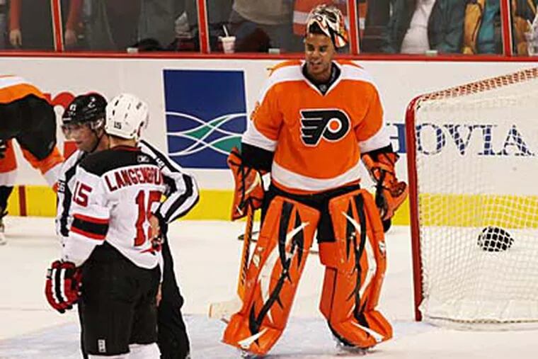Flyers goalie Ray Emery has words with Devils Jamie Langenbrunner after the Devils player is called for roughing with less than one second left in the game. Emery had 33 saves in the game. ( David M Warren / Staff Photographer )