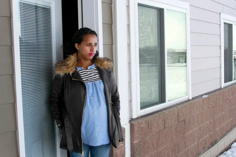 Kulule Amosa steps out of the apartment she shares with her husband who works at the Smithfield Foods pork processing plant in Sioux Falls, S.D. He tested positive for the coronavirus after an outbreak at the plant.