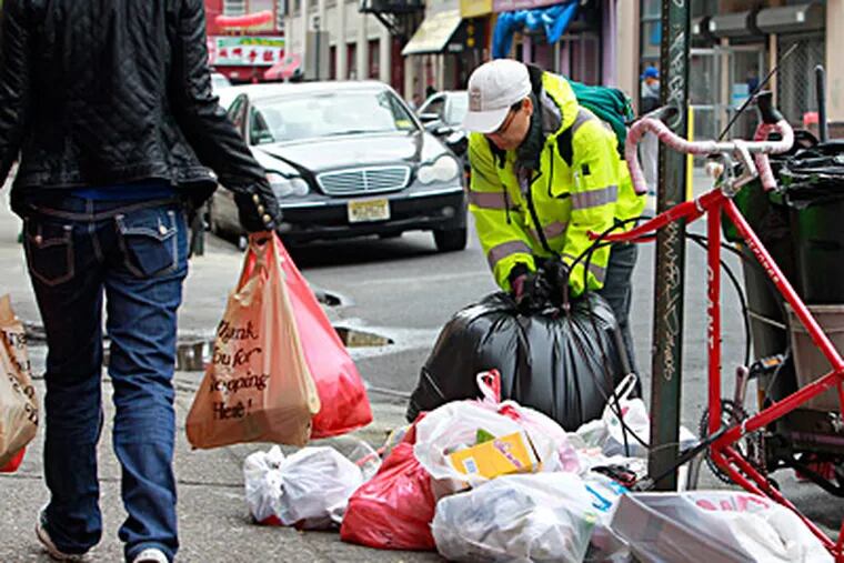 Susan Chung, member of the Chinatown cleanup crew, patrols the streets, collecting trash on the sidewalk. AKIRA SUWA / Staff Photographer