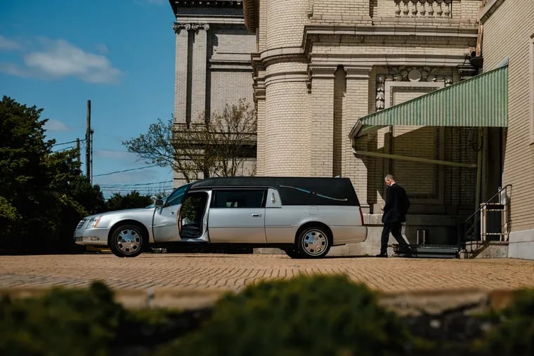 Nick Cassese puts cremated remains in a hearse outside the Fresh Pond Crematory and Columbarium in Middle Village, N.Y., a stately yellow brick building from 1884 in the New York City borough of Queens.