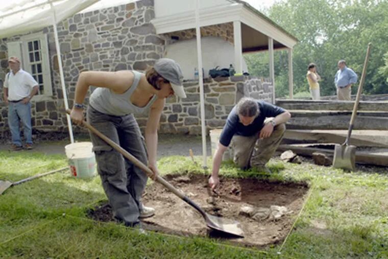 Temple University graduate students Katie Cavallo and Joe Blondino do an archaelogical dig, searching for Gen. George Washington's original dining room, at Valley Forge National Park. (April Saul / Staff Photographer)