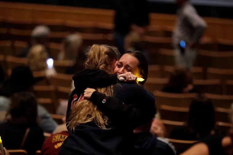 Mourners embrace during a vigil to remember victims of a mass shooting Thursday, Nov. 8, 2018, in Thousand Oaks, Calif. Terrified patrons hurled barstools through windows to escape or threw their bodies protectively on top of friends as a Marine combat veteran killed multiple people at a country music bar in an attack that added Thousand Oaks to the tragic roster of American cities traumatized by mass shootings. (AP Photo/Marcio Jose Sanchez)