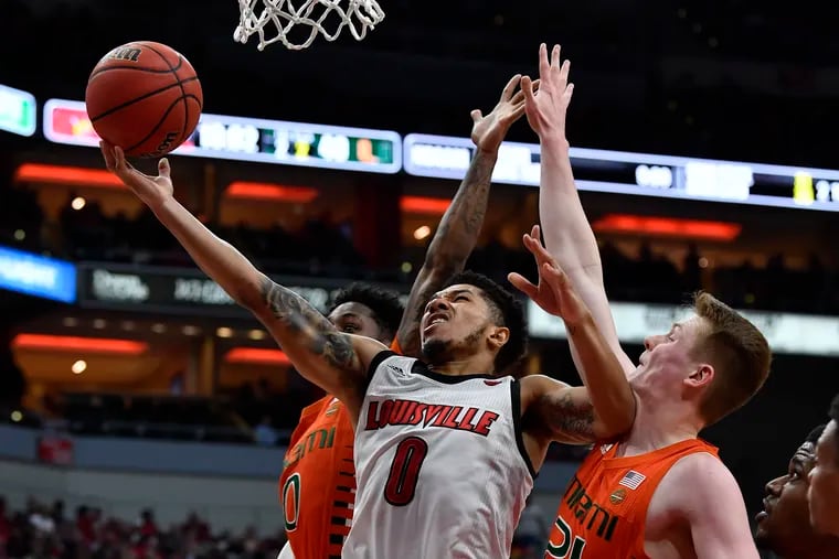 Louisville guard Lamarr "Fresh" Kimble (0) shoots between Miami guard Chris Lykes (0) and forward Sam Waardenburg (21) during the second half of an NCAA college basketball game in Louisville, Ky., Tuesday, Jan. 7, 2020. Louisville won 74-58. (AP Photo/Timothy D. Easley)