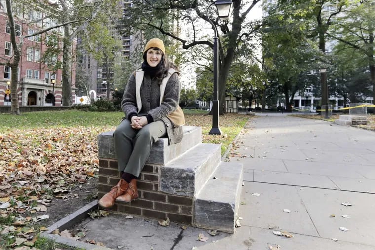 Artist Kaitlin Pomerantz sits on a stoop in Washington Square Park.