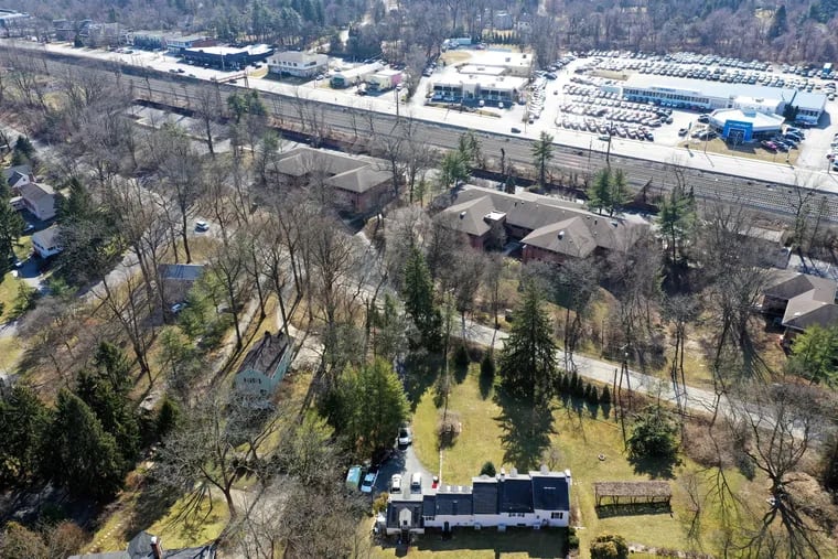 The proposed site for the Solera assisted-living and memory-care complex (above the road and below the train tracks) sits across from a residential neighborhood, in which dozens of residents have banded together to oppose the plan.