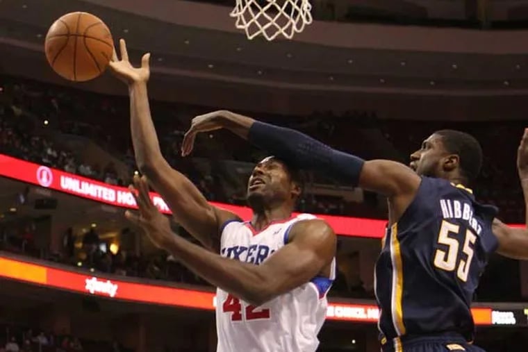 Roy Hibbert (right), here blocking a shot by the Sixers' Elton Brand, is now player development coach for the Sixers.