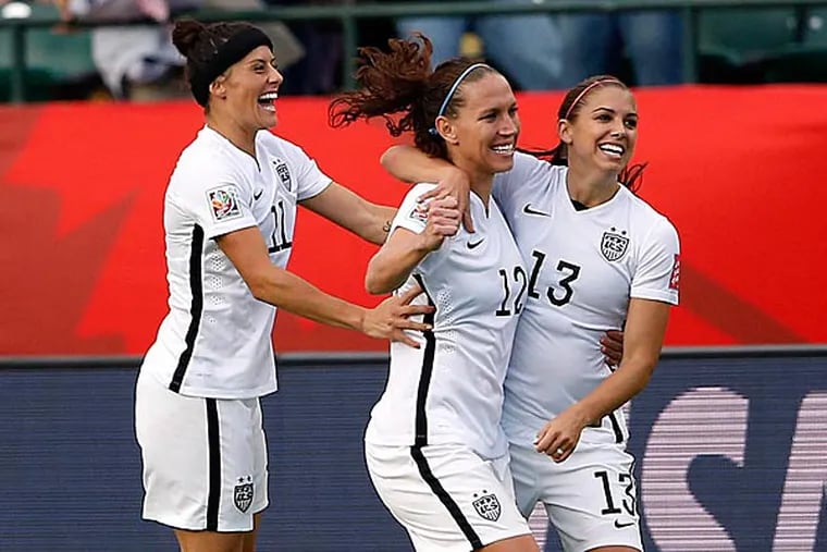 United States forward Alex Morgan (13) celebrates with midfielder Lauren Holiday (12) and defender Ali Krieger (11) after scoring a goal during the first half against the Colombia in the round of sixteen in the FIFA 2015 women's World Cup soccer tournament at Commonwealth Stadium. (Michael Chow/USA Today)