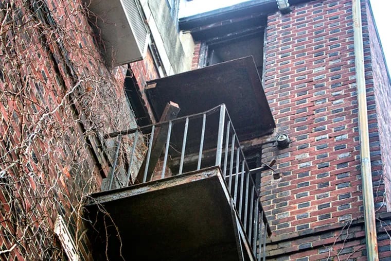 Tragedy struck early Sunday when a 3rd-floor balcony collapsed at the John C. Bell House, a historic house at 229 S. 22nd St., sending three people to the pavement below. One victim has died and two were listed in critical condition. This is a view looking up with debris on the 2nd floor balcony and the missing railing on the 3rd floor balcony. (ED HILLE/Staff Photographer)