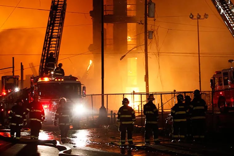 Firefighters battle a five alarm fire in a warehouse on York Street near Kensington Ave. in the Kensington section of Philadelphia on Monday April 9, 2012.  (For the Daily News/ Joseph Kaczmarek)
