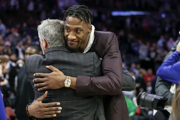 Brett Brown greets former Sixer Robert Covington after the Timberwolves game at the Wells Fargo Center on Jan. 15.
