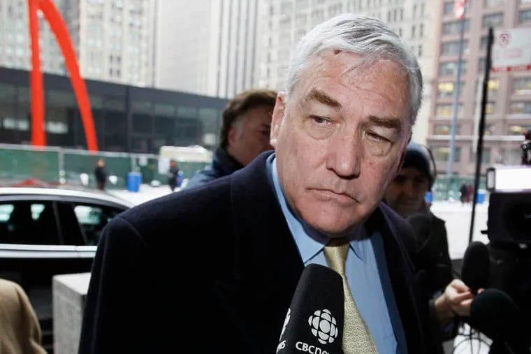 FILE - In this Jan. 13, 2011, file photo, Conrad Black arrives at the federal building in Chicago. President Donald Trump has granted a full pardon to Black, a former newspaper publisher who has written a flattering political biography of Trump. Black's media empire once included the Chicago Sun-Times and The Daily Telegraph of London.