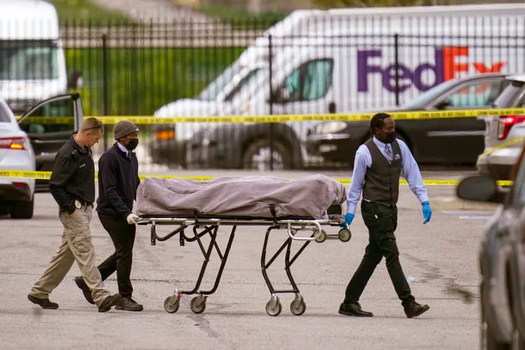 A body is taken from the scene where multiple people were shot at a FedEx Ground facility in Indianapolis, Friday, April 16, 2021. A gunman killed several people and wounded others before taking his own life in a late-night attack at a FedEx facility near the Indianapolis airport, police said.