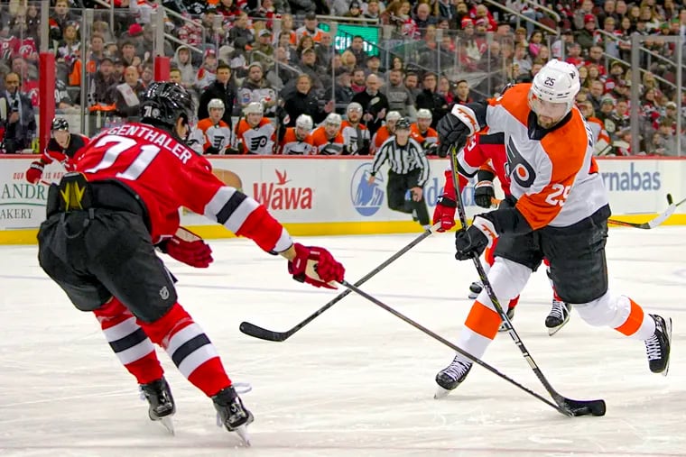 Devils defenseman Jonas Siegenthaler blocks the shot of Flyers center Ryan Poehling during the first period on Dec. 19.