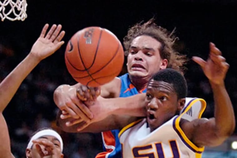 Florida&#0039;s Joakim Noah and LSU&#0039;s Dameon Mason (right) battle furiously for control of a rebound in the first half in Baton Rouge, La. Louisiana State had lost three straight and nine of 10 before the win.