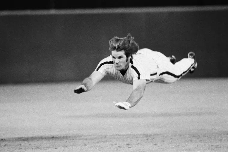 In this June 3, 1981 file photo, Pete Rose dives headfirst for third base during a baseball game against the New York Mets in Philadelphia.
