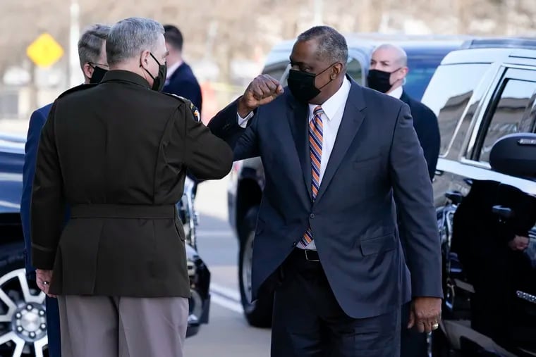 Defense Secretary Lloyd Austin, right, greeted Chairman of the Joint Chiefs of Staff Mark Milley as he arrived at the Pentagon on Friday.