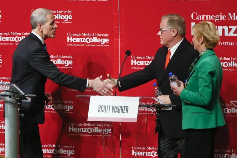 Paul Mango (left) and Scott Wagner shake hands after a debate in January as Laura Ellsworth looks on. These days Wagner and Mango are not so friendly.
