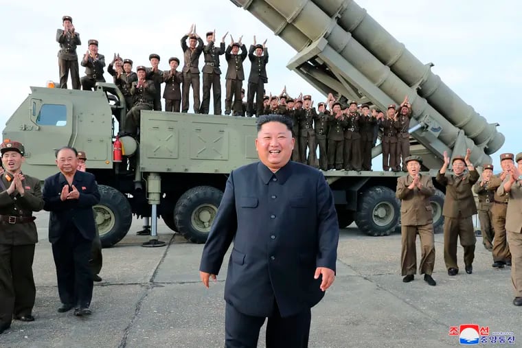 This Saturday, Aug. 24, 2019, photo provided Sunday, Aug. 25, by the North Korean government, shows North Korean leader Kim Jong Un, center, smiles after the test firing of an unspecified missile at an undisclosed location in North Korea. North Korea fired two suspected short-range ballistic missiles off its east coast on Saturday in the seventh weapons launch in a month, South Korea's military said, a day after it vowed to remain America's biggest threat in protest of U.S.-led sanctions on the country. The content of this image is as provided and cannot be independently verified. Korean language watermark on image as provided by source reads: "KCNA" which is the abbreviation for Korean Central News Agency.