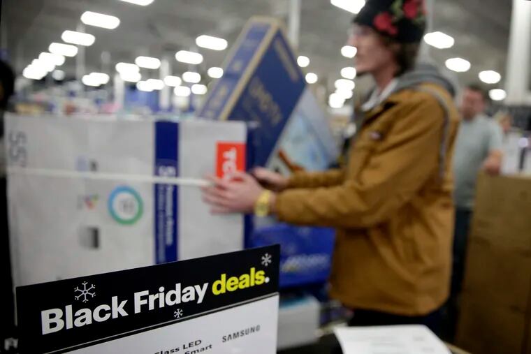 FILE photo shows shoppers waiting in line to buy televisions as they shop during an early Black Friday sale at a Best Buy store on Thanksgiving Day in Overland Park, Kan. (AP Photo/Charlie Riedel, File)
