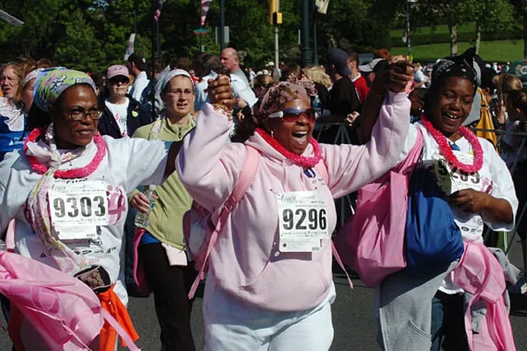 (From left) Yolanda Erwin, sister Jackie Erwin-Brown, and friend Lafarae Fennell celebrate as they cross the finish line at the Susan G. Komen Philadelphia Race for the Cure in May 2009.