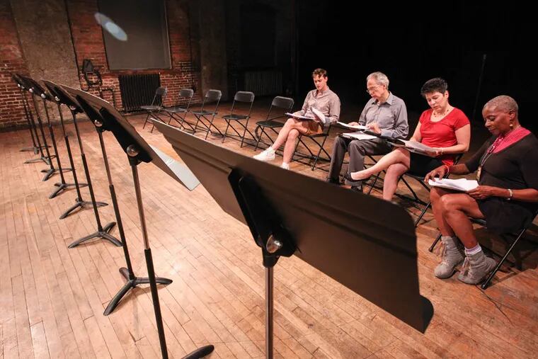During rehearsal for a play based on dozens of interviews with LGBT Catholics, (from left) David Reece Hutchison, Terence Gleeson, Maria Wolf (playing Margie Winters) and Rhonda Moore read lines. (STEVEN M. FALK/Staff Photographer)