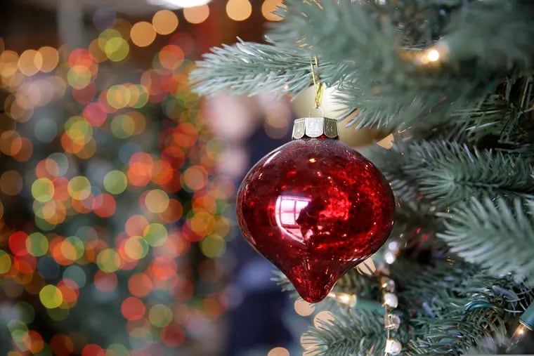 In this Friday, Nov. 30, 2018, photo, an ornament hangs on an artificial Christmas tree at the Balsam Hill Outlet store in Burlingame, Calif.
