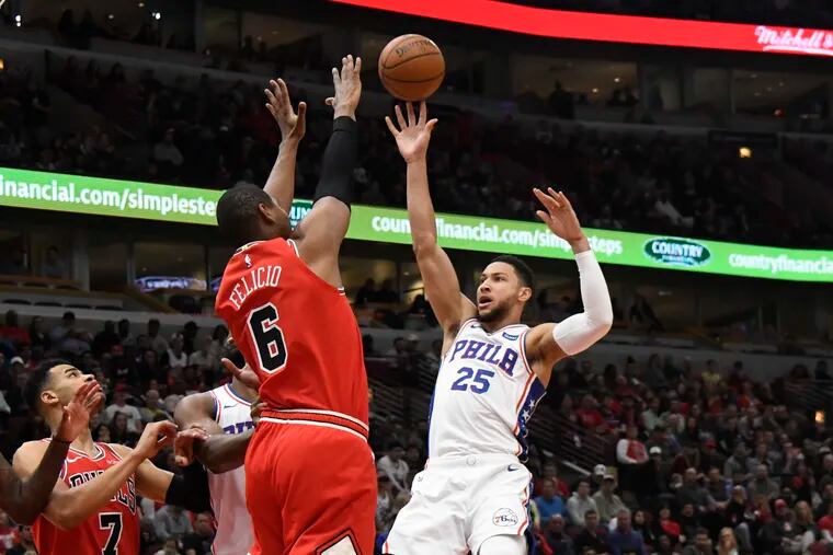Philadelphia 76ers guard Ben Simmons (25) shoots as Chicago Bulls forward Cristiano Felicio (6) defends during the first half of an NBA basketball game Saturday, April 6, 2019, in Chicago. (AP Photo/David Banks)