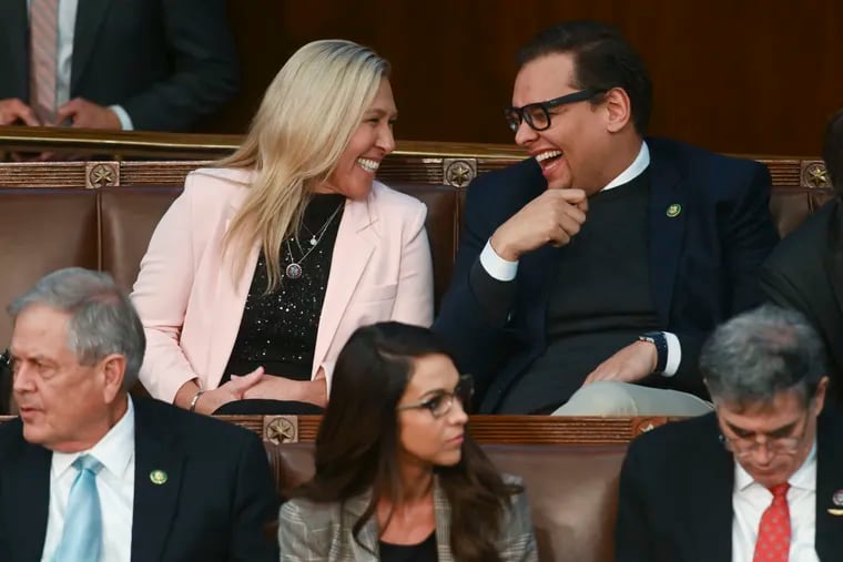 Rep. Marjorie Taylor Greene (R., Ga.) laughs with Rep. George Santos (R., N.Y.) during a vote for speaker of the House earlier this month.