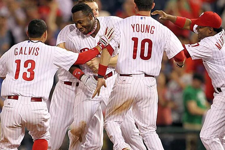 Phillies' Domonic Brown celebrates his game RBI single with this
teammates during the bottom of the ninth-inning against the Washington
Nationals played on Monday, June 17, 2013.  (Yong Kim/Staff
Photographer)