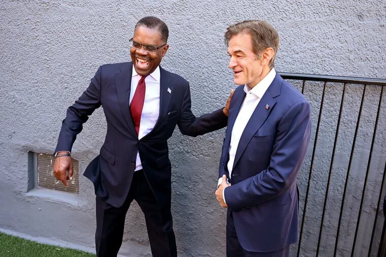 Republican candidate for the U.S. Senate Mehmet Oz is greeted by Calvin Tucker (left), deputy chairman of the Republican Party of Pennsylvania, as he visits the Republican National Committee’s Black American Engagement Center in Germantown in June. Oz was back in Philadelphia for a string of campaign events this weekend.