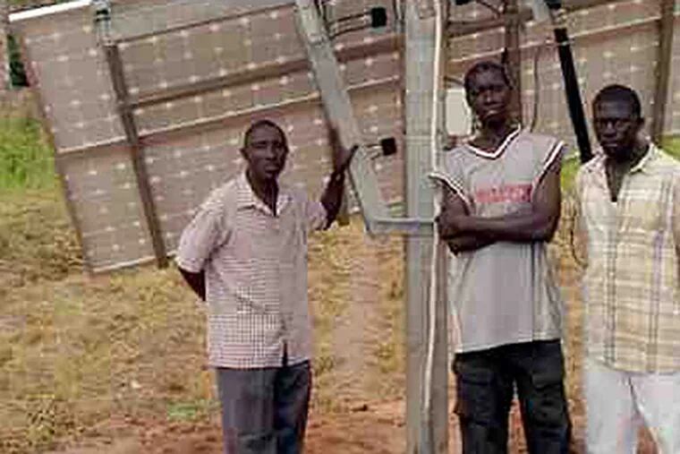 At the Somita Clinic in Gambia, staff members stand near the new photovoltaic panels. Power Up Gambia raised funds for the system, its second project there. (GamSolar photo)